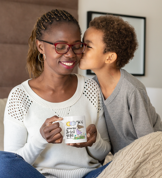 A woman holding a mug with a design "God is with her, she will not fall.