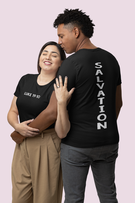 A couple wearing a christian shirt. The woman wearing a black shirt with the words Luke 19:10 on a white bold horizontal font, and the man wearing a black shirt with the word Salvation on a white bold vertical font